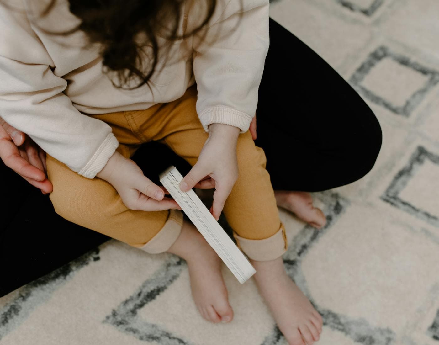 A child practicing at home with a parent nearby.